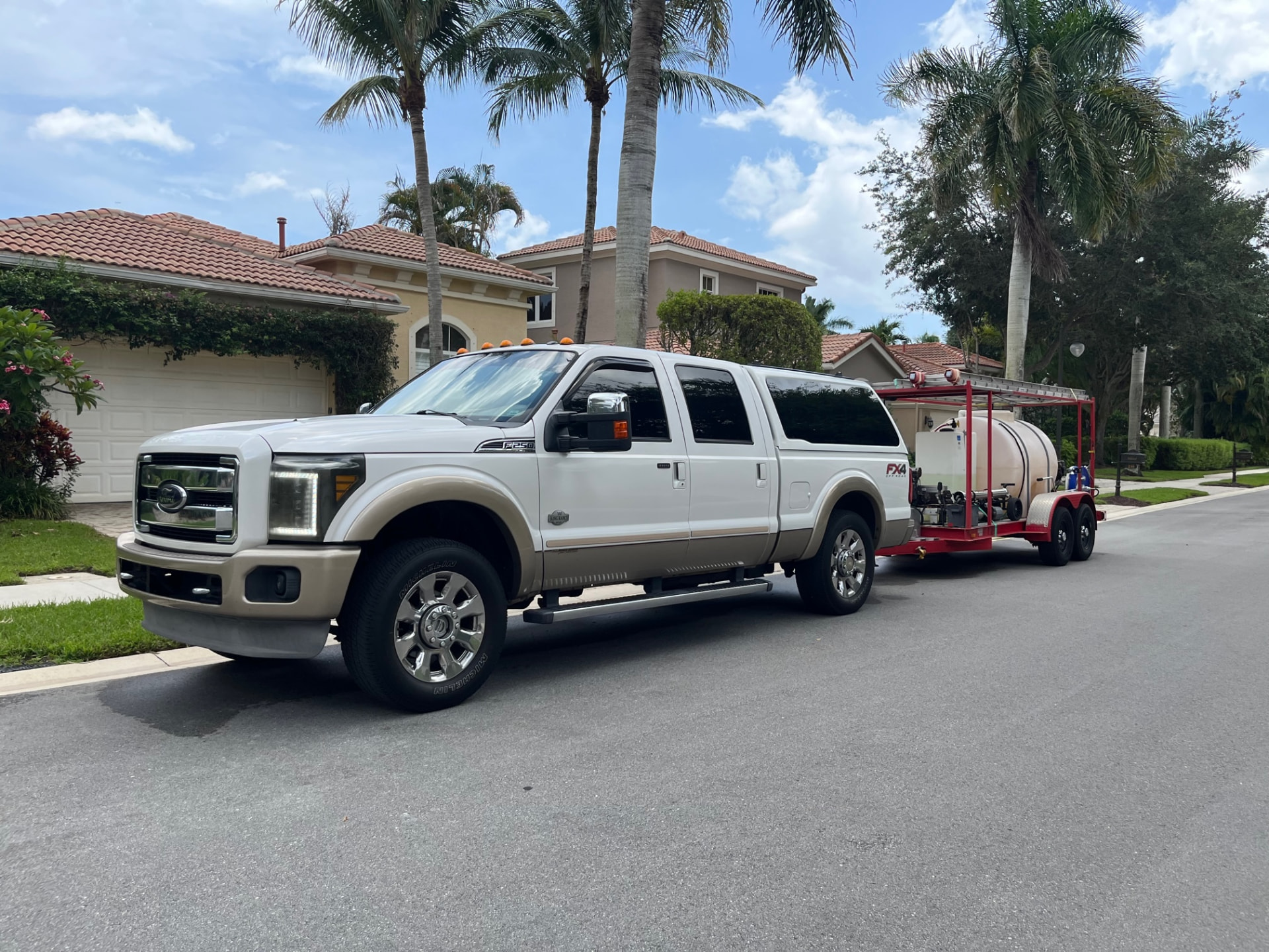 Palm Beach Hydro Clean truck and pressure washing rig parked at a Palm Beach County home